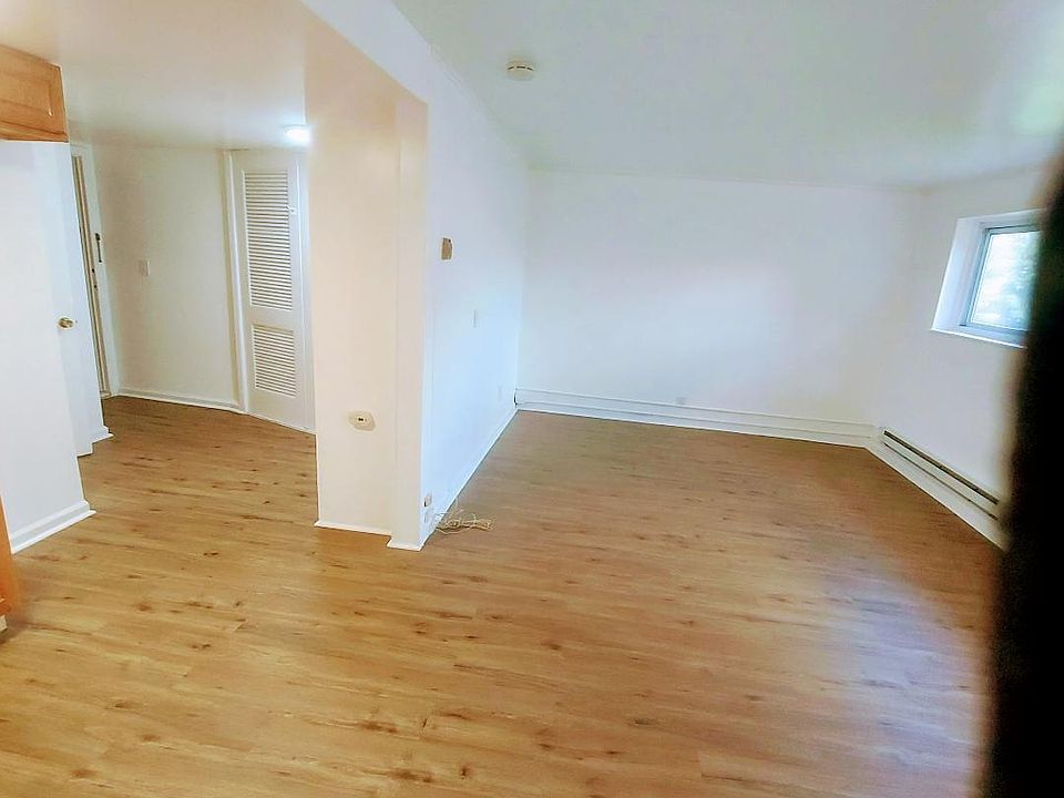 12x20 open bedroom/living room area adjacent to 5x8 open kitchen and hall with 2 closets, new floors