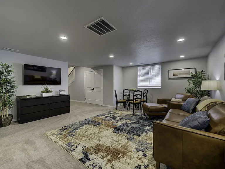 Basement Living Room
Second living room with comfortable seating to include a sofa sleeper for extra guests, large smart TV, four-person game table, books, and board games