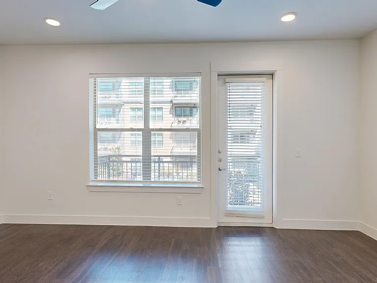 Apartment living room with wood-style flooring.
