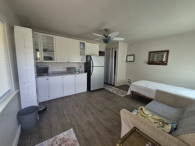 Cooking area of studio. Includes a sink and microwave and hot plate, and I believe a pizza over.