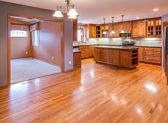 The informal dining and kitchen areas have beautiful hardwood floors and lighting fixtures. Jut beyo