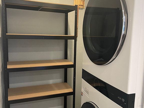 Walk-in pantry and laundry area right off the kitchen. Brand new LG washer/dryer tower with WiFi. New tankless water heater so you'll never run out of hot water!