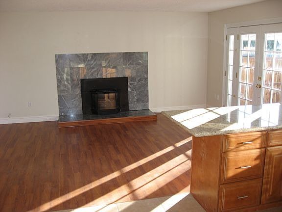 Family room with a gas insert marble fireplace