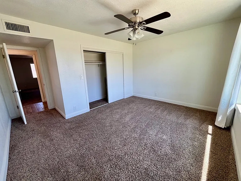3rd large bedroom and closet. New fan, lights, adjacent to the shared bathroom.