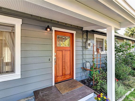 Charming front enrty with established garden beds.