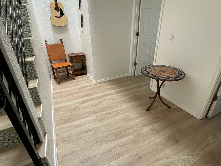 Downstairs area with access to built-in storage, utility closet, and access to Primary and Secondary bedrooms