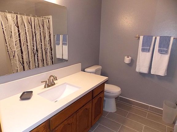 The large spotlessly clean bathroom has a shower and tub.