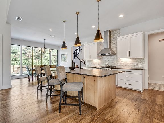 Gourmet kitchen has massive granite island and cabinet storage galore.