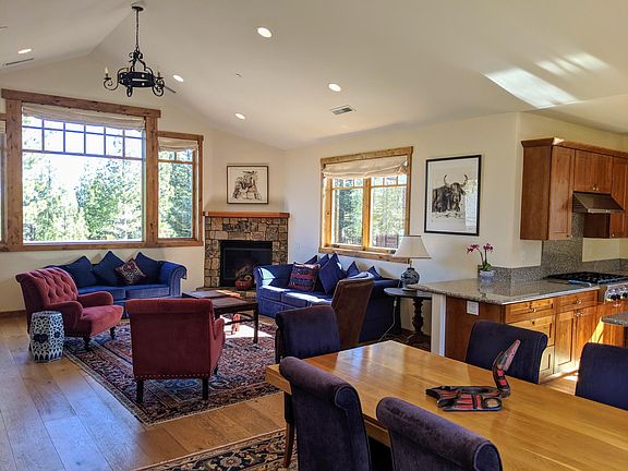 Open plan living area with views of golf course and mountain and access to two decks; Gas fireplace