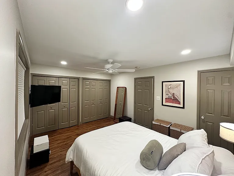 Three custom closets for ample storage, black-out blinds, a flexible mounted smart TV, quiet ceiling fan.