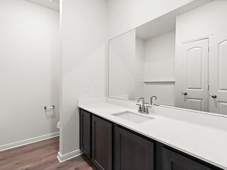 The secondary bathroom has a large vanity space.