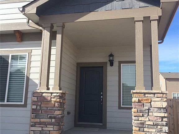 Wonderful covered front porch with stone accents.