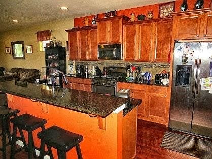 open concept kitchen/dining/living room with stainless steel