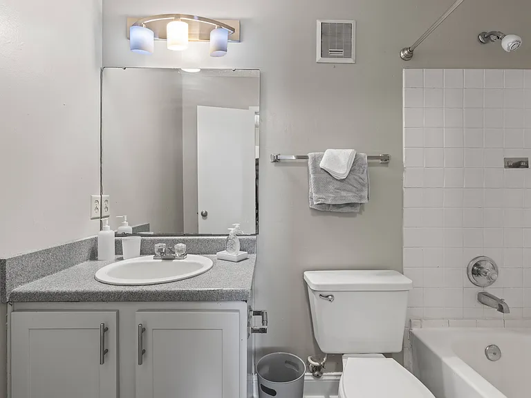 Our Montgomery apartments at Stratford Village feature clean bathrooms with toilet and vanity sink, professionally operated by Highlands Vista Group.