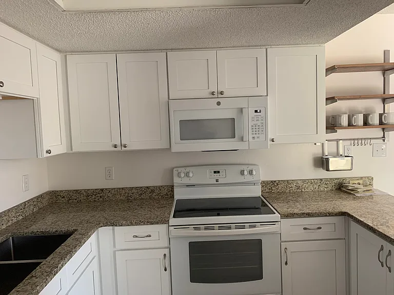 Bright kitchen with new cabinetry, granite countertops