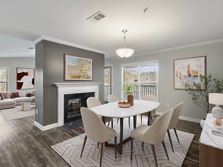 Renovated apartment dining area centered around a warm fireplace setting