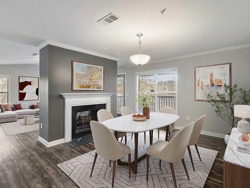 Renovated apartment dining area centered around a warm fireplace setting
