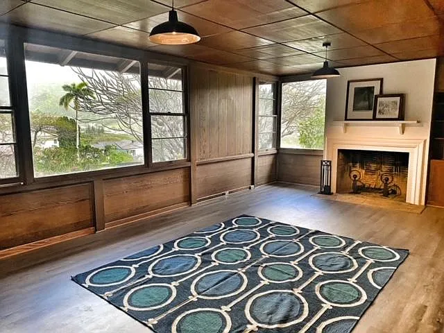 Spacious great room with original fireplace (decorative) and large picture windows with valley views