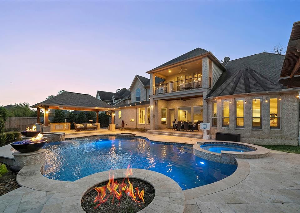 Welcome to 25302 E Titan Springs Dr. The Resort Style back yard is ideal for family fun and entertainment. Features include: Pool & Spa, Covered Cabana, Covered Kitchen, Fire Pit, Waterfall flanked by dual Fire Bowls, and plenty of seating.