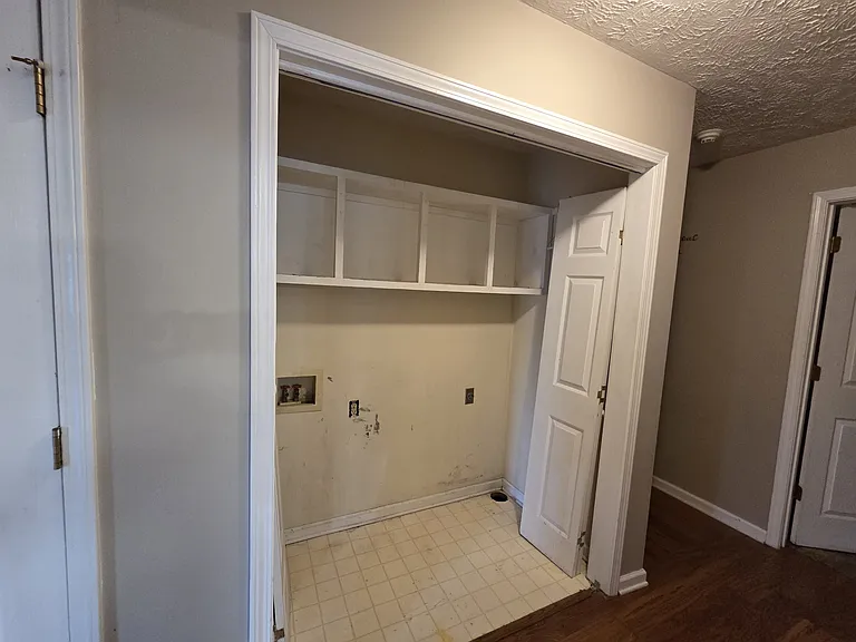 Laundry room with washer/dryer hook-ups and storage