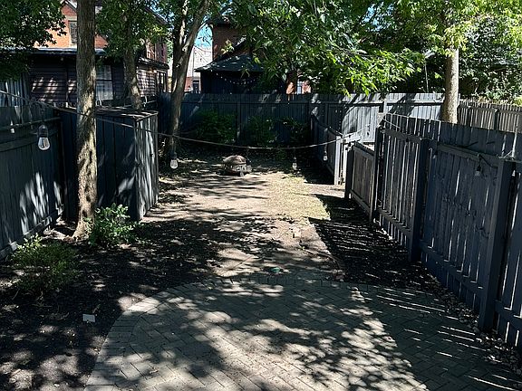 Private back brick patio w/ fenced in yard and shed (+ fire pit)