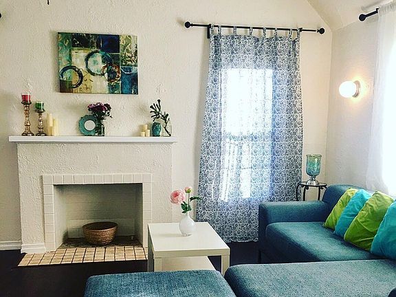 Bright & airy living room with faux fireplace.