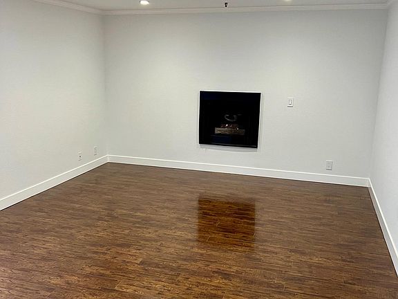 Large Living Room with Fireplace, LED Lighting and Hardwood Floors