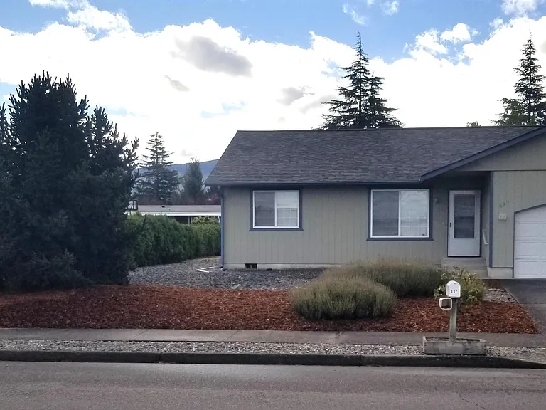 Additional view of the front entrance and garage.