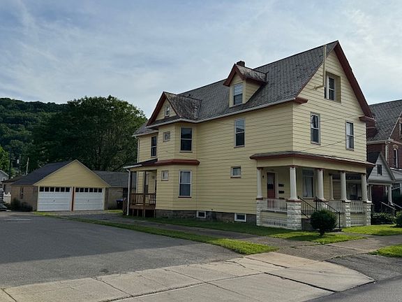 Side view of House; Apartment is entire first floor; One off-street parking space