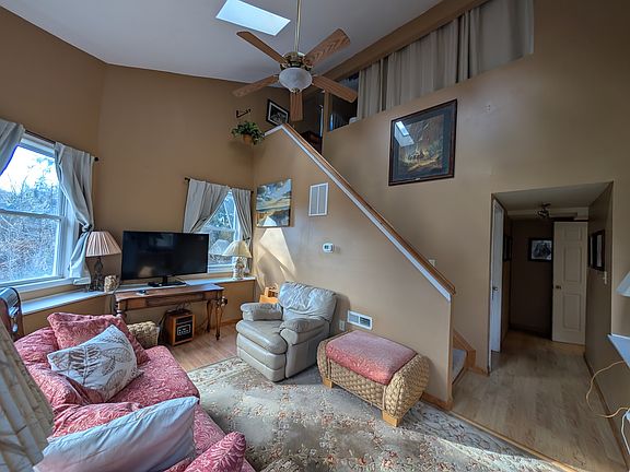 Sunroom + loft stairs (open loft sleeping area above)