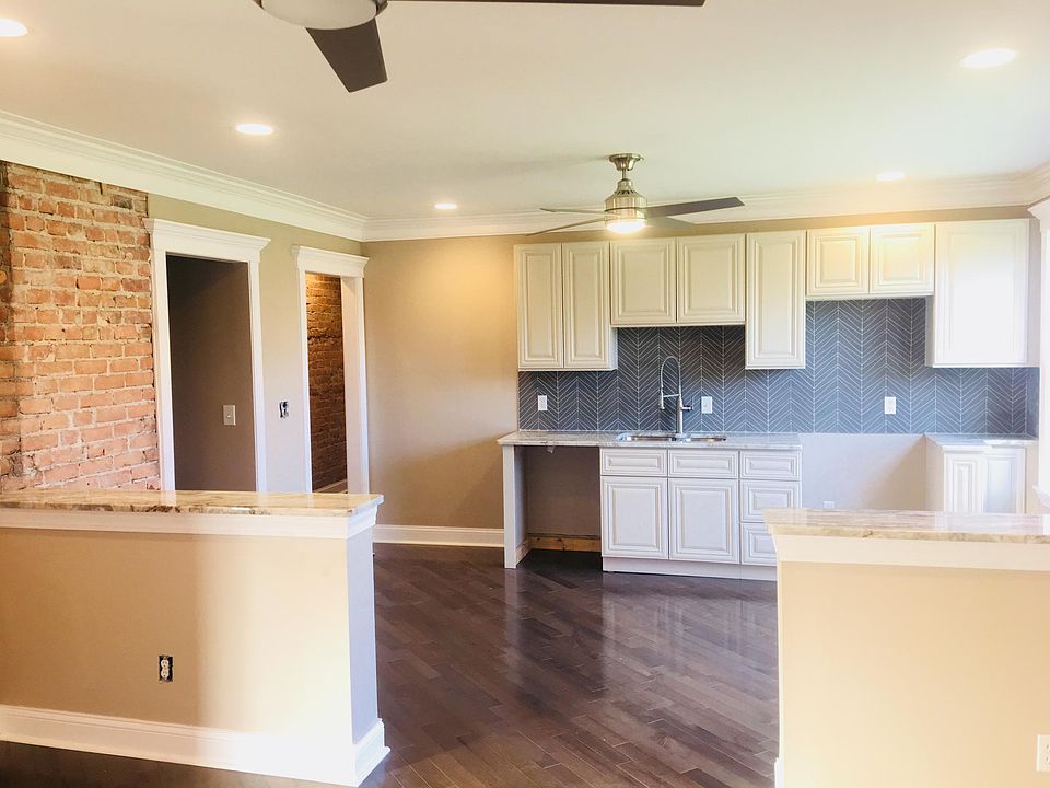 Open floor plans with hardwood flooring, upgraded backsplash