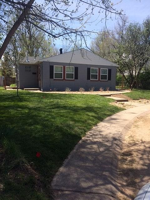 Front View: Home has been updated with a fenced yard on both sides.