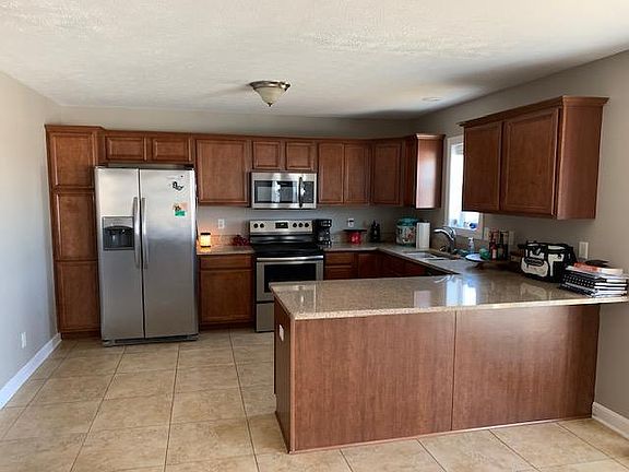 Large kitchen with appliances including dishwasher