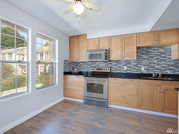 Large kitchen with gorgeous shaker cabinets, granite slab, soft close cabinetry, stainless steel appliances and new back splash.
