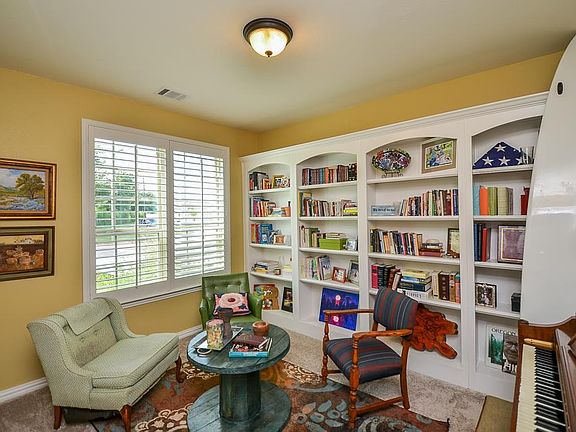 Study enclosed with French doors features built ins & Plantation shutters.