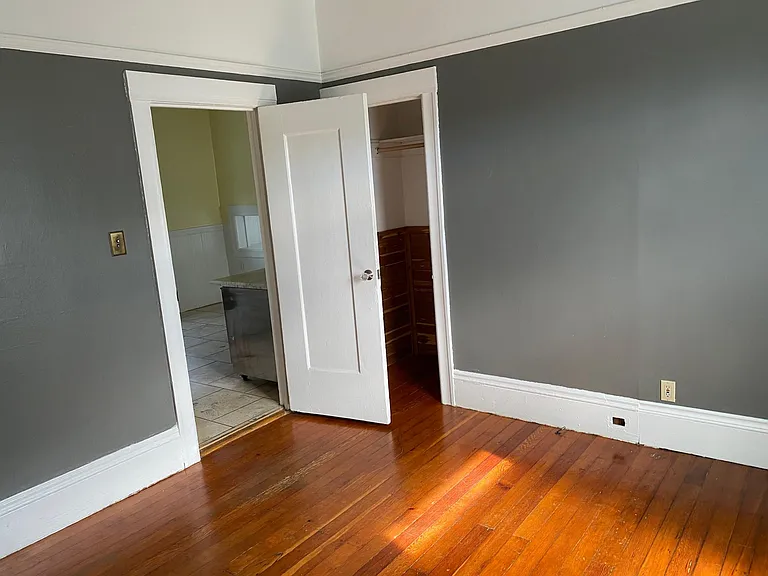 Second bedroom off of the kitchen, with closet on right