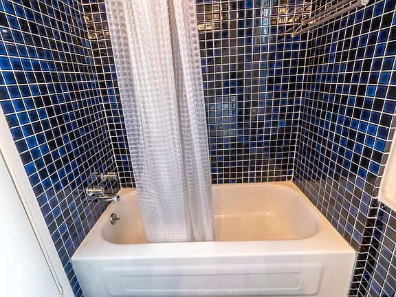 tiled bathroom with bathtub