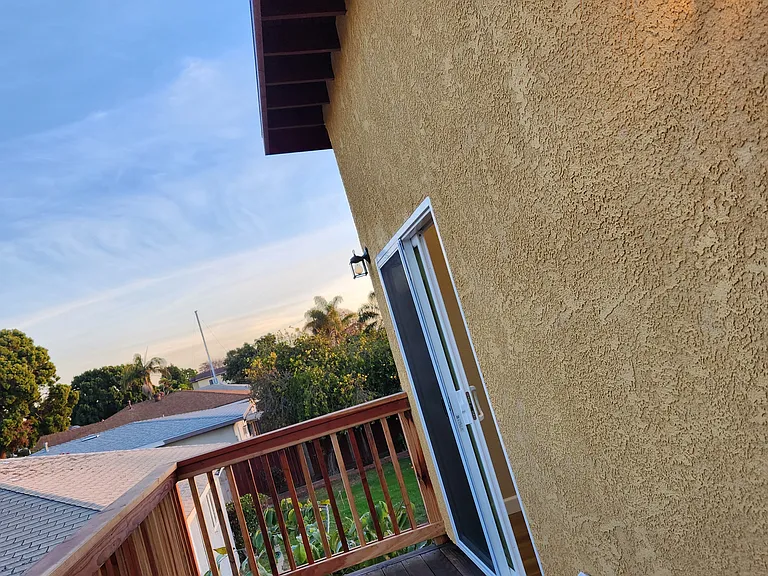 Outside view of patio deck from master bedroom, upstairs.