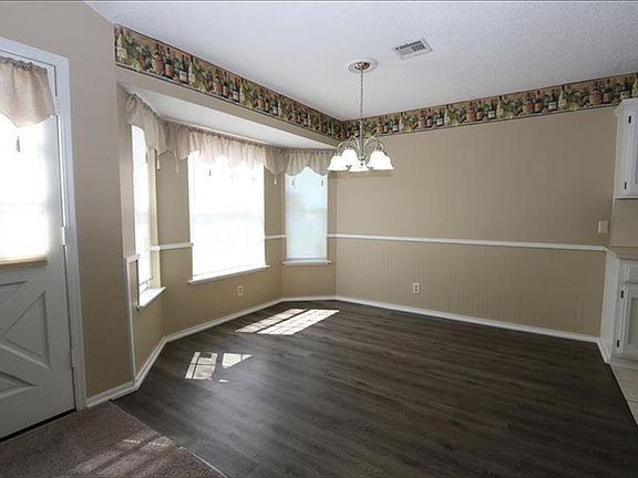 Breakfast Nook with new light fixture and wood look vinyl plank flooring