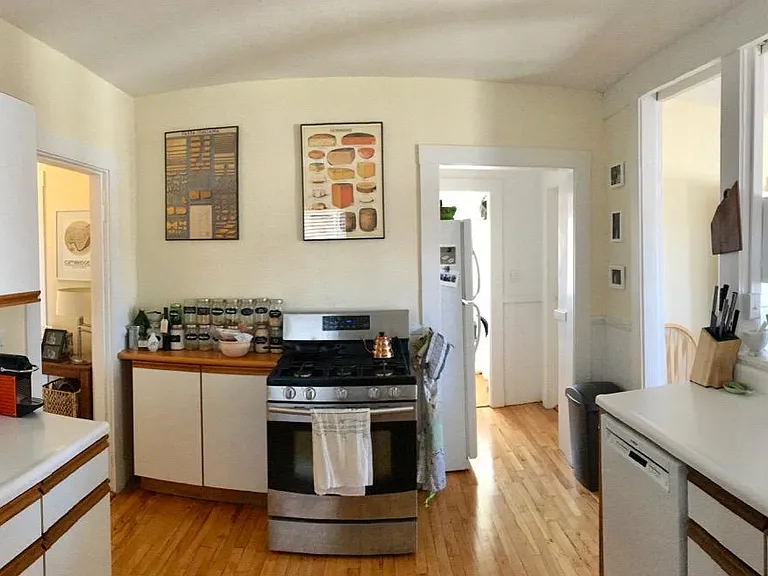 Kitchen facing stove, fridge, and laundry area