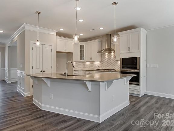 kitchen with island and farm-style
 stainless steel sink