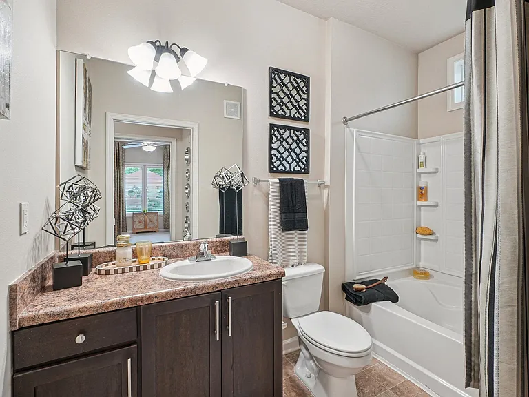 Modern apartment bathroom with spacious vanity and contemporary finishes at Village at Broadstone Station in Apex, North Carolina