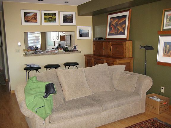 Granite counter bar off the kitchen, or this can be an extra dining area. Sofa in living area faces a gas fireplace.