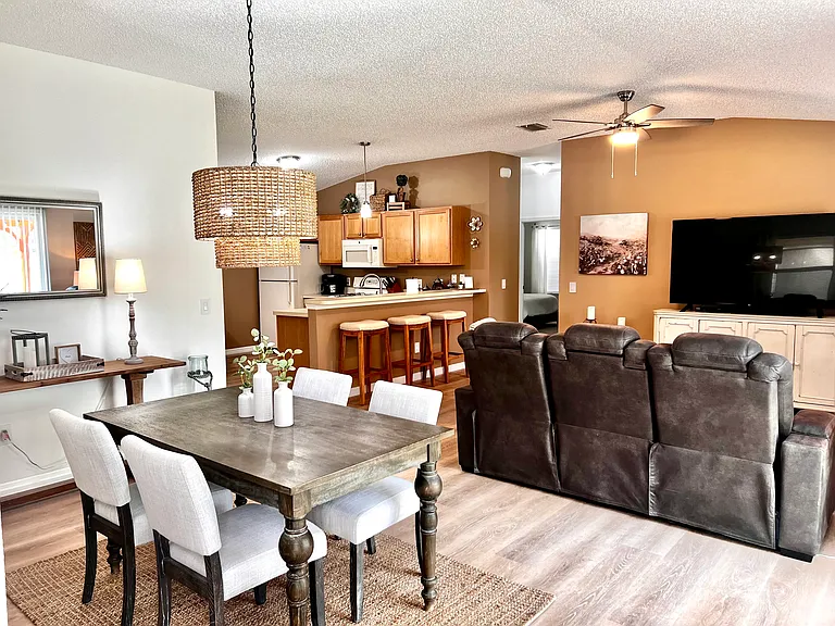Entrance to the open concept with dinning and TV area with a 65" TV just off of the kitchen.