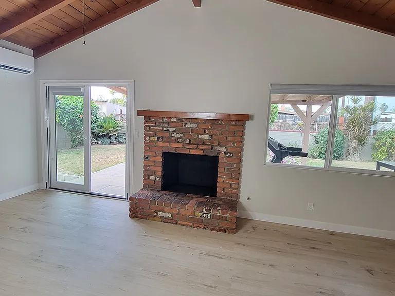 Fireplace makes it look so cozy yet airy with the high ceilings!