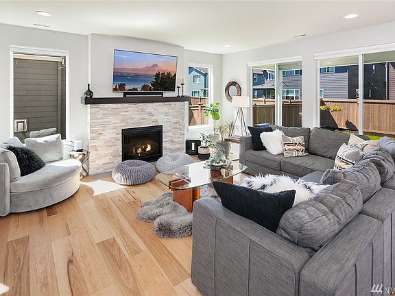 Open concept great room with custom fireplace.