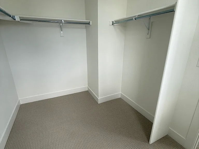Primary bedroom walk-in closet