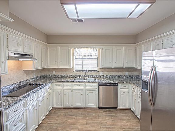 Image 5: Kitchen has been updated with recent appliances and granite counters...