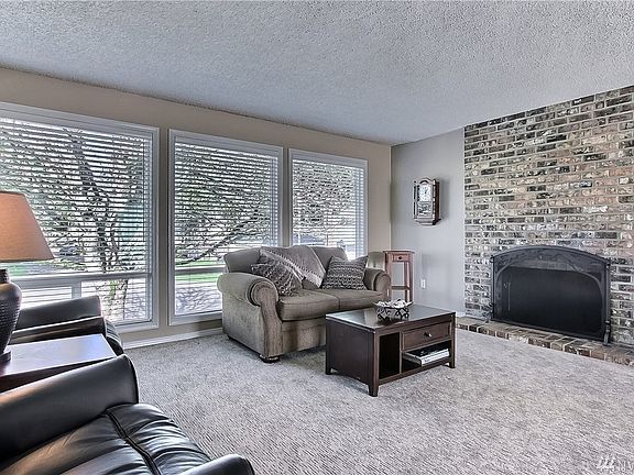 Upstairs living room with fireplace and huge windows!
