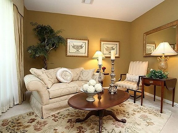 Formal living room features custom drapes which add distinction to this area.
